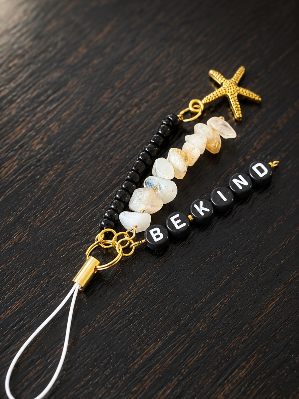BEKIND Phone Charm with Gold Starfish and Black Beads